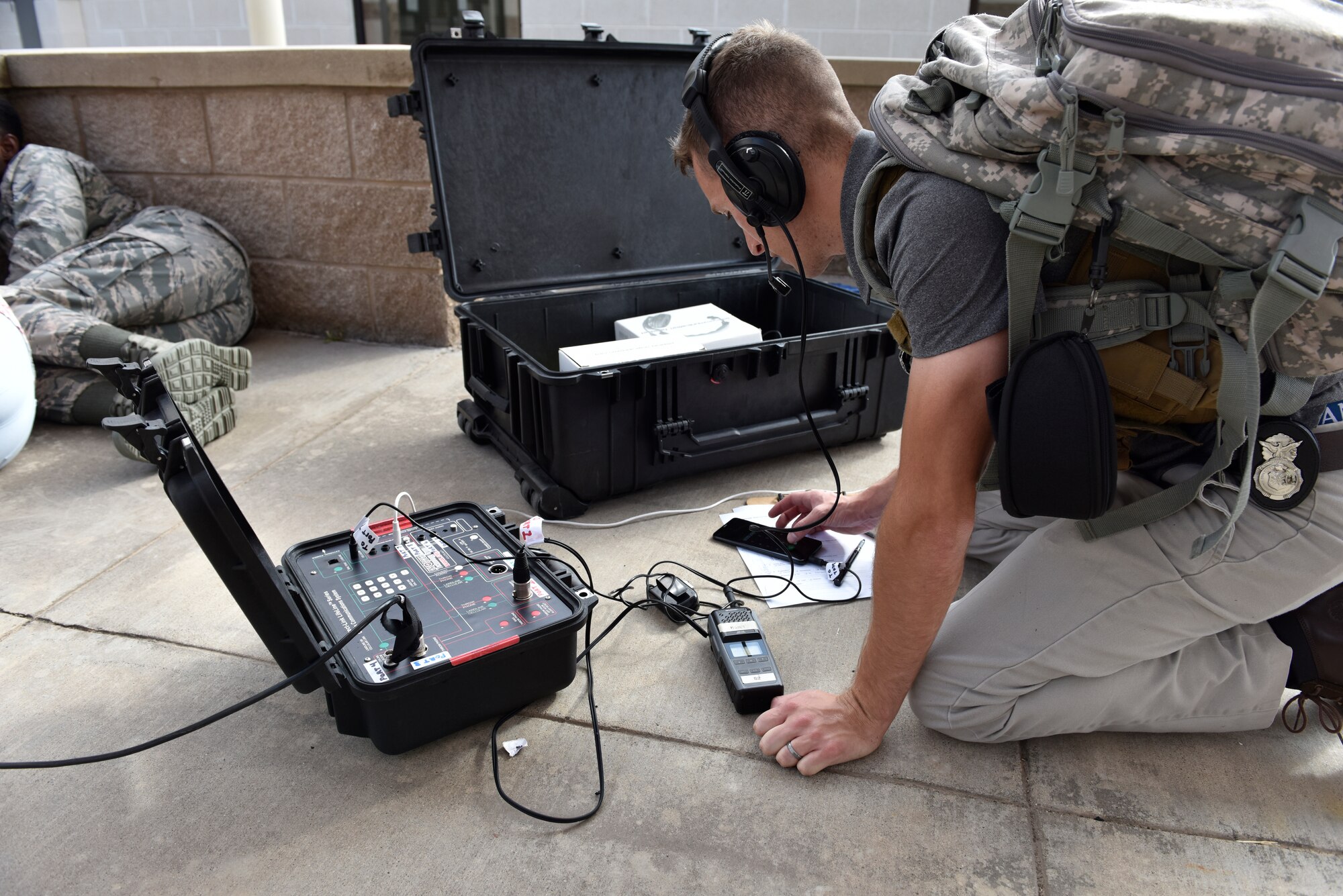 Staff Sgt. Tyler Dyer, 47th Security Forces Squadron investigator, negotiates a simulated hostage situation during an active shooter training at Laughlin Air Force Base, Texas, July 22, 2019. The response and negotiation portion of the exercise lasted for nearly two hours and was aimed at bolstering crisis readiness and response capabilities. (U.S. Air Force photo by Staff Sgt. Benjamin N. Valmoja)