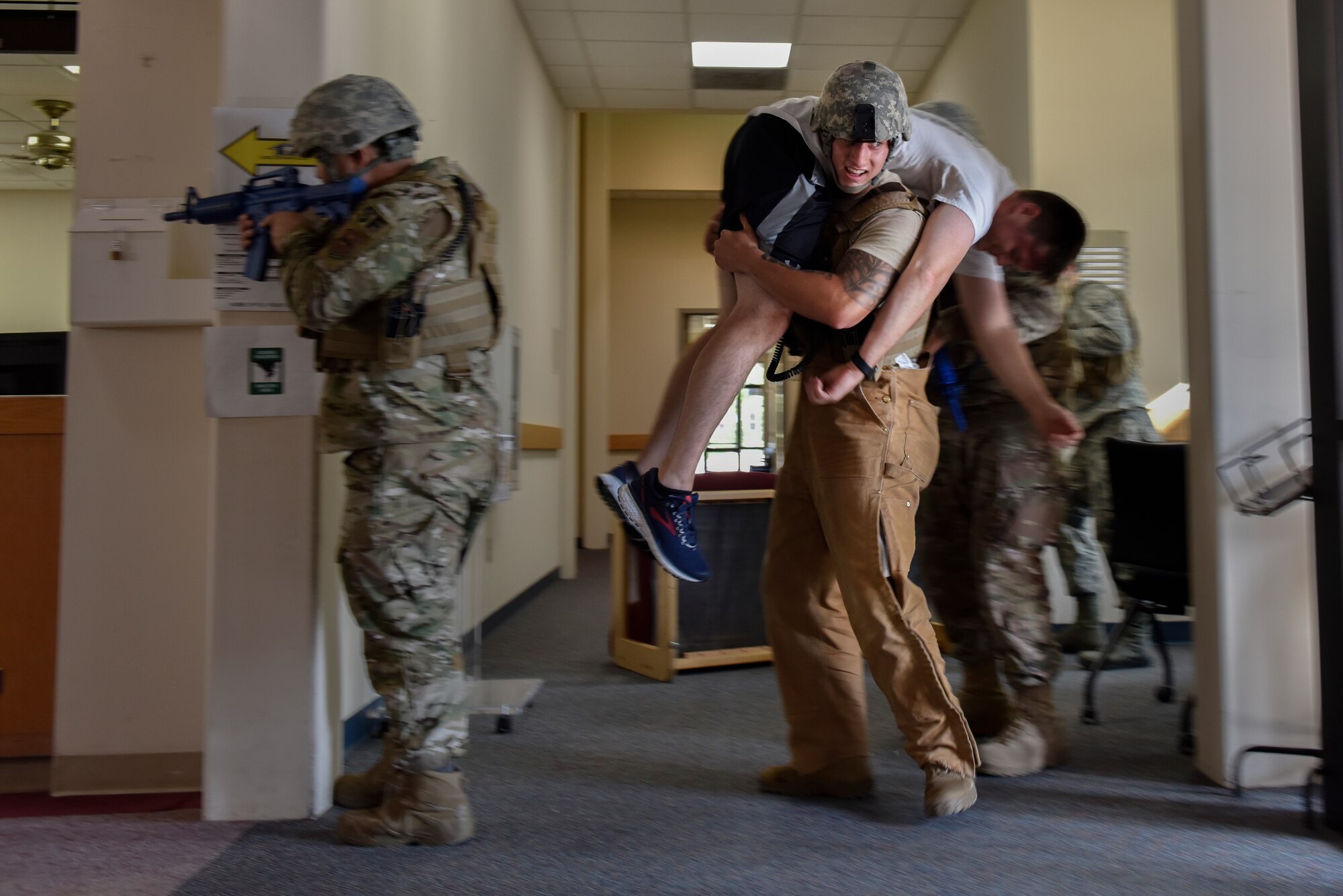 Staff Sgt. Dakota Farrow, 47th Security Forces Squadron military working dog handler, evacuates a simulated active shooter victim during a training exercise at Laughlin Air Force Base, Texas, July 22, 2019. The exercise, aimed at bolstering crisis readiness and response capabilities, simulated a hostage situation that lasted for nearly two hours. (U.S. Air Force photo by Staff Sgt. Benjamin N. Valmoja)