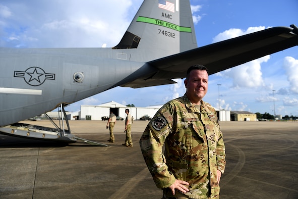 A man stands in front of a C-130J