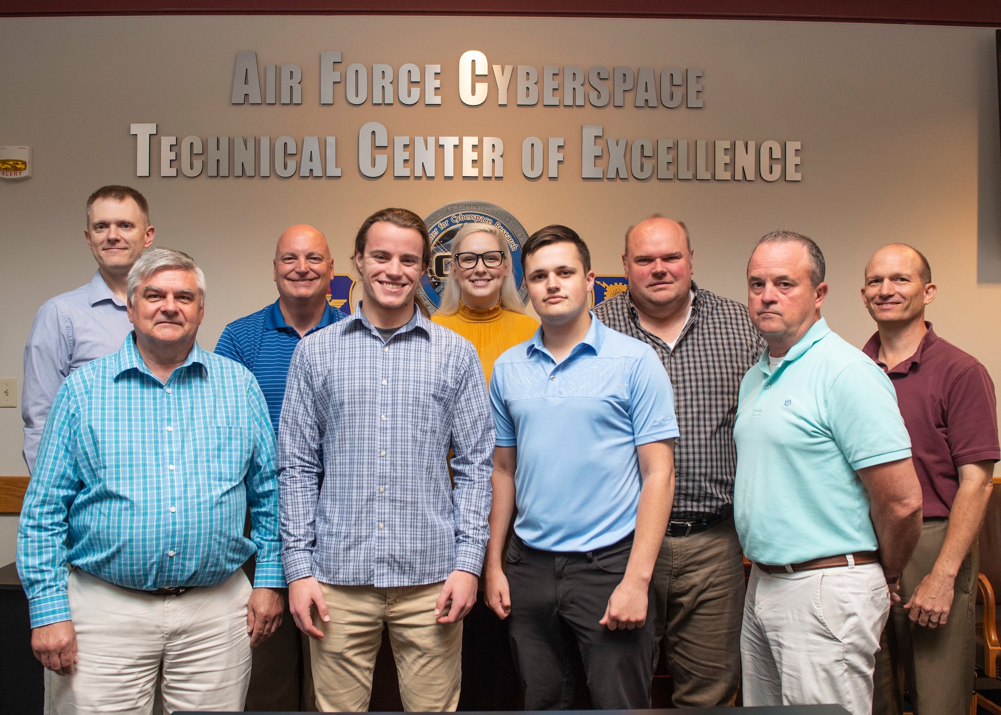 Back left, Air Force Institute of Technology Assistant Professor of Cyber Systems Mark Reith, second from right, Matthew Dever, Air Force Cyberspace Technical Center of Excellence, assistant to the director, and Reith’s graduate students, created a cloud based educational hub as a research project to improve user motivation and engagement with training. (U.S. Air Force photo/Wes Farnsworth)