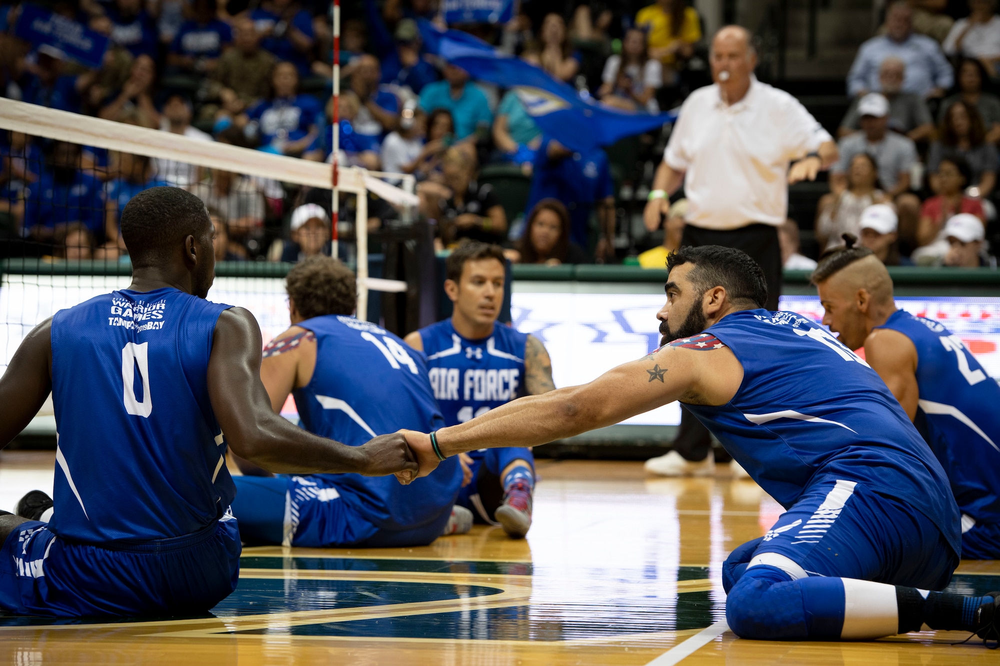 Staff Sgt. Kevin Greene (left) shakes hands with Master Sgt. (Ret.) Andres Rodriguez after he scores a point during a sitting volleyball competition, June 30, 2019, in Tampa, Florida. Rodriguez is Team Air Force’s sitting volleyball captain and led the team to win the Silver medal during this year’s 2019 Department of Defense sitting volleyball competition. (U.S. Air Force photo by Staff Sgt. Sahara L. Fales)