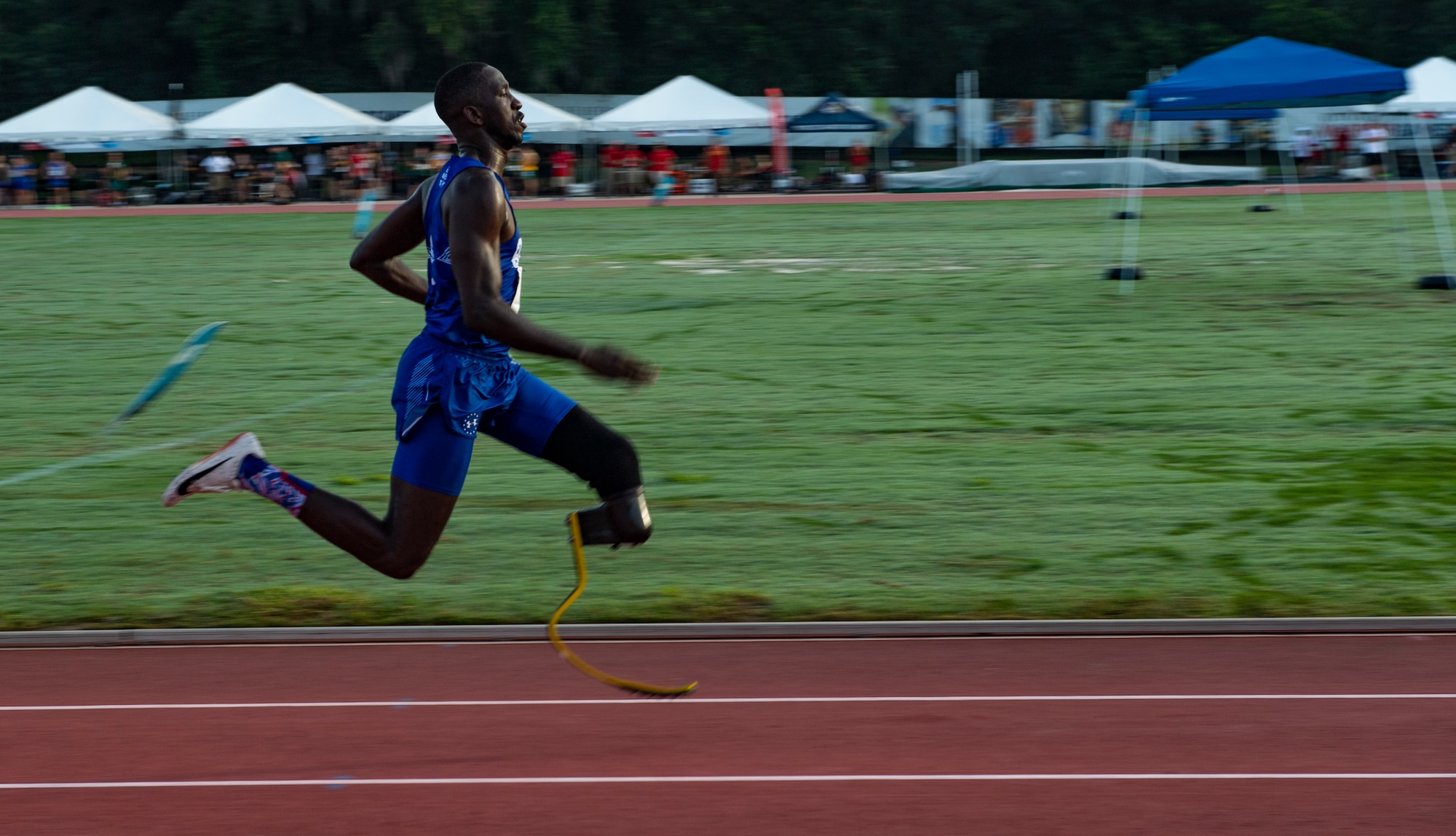 U.S. Air Force Staff Sgt. Kevin Greene, Team Air Force athlete, competes in the 200-meter dash during the Department of Defense Warrior Games track competition in Tampa, Fla., June 22, 2019. Approximately 300 U.S. military and international service members and veterans will participate in the 2019 Warrior Games. The athletes represent the U.S. Army, Marine Corps, Navy, Air Force and Special Operations Command. This year, athletes from the United Kingdom Armed Forces, Australian Defence Force, Canadian Armed Forces, the Netherlands Defence Force and the Danish Defence Force are also competing.(U.S. Air Force photo by Staff Sergeant James R. Crow)