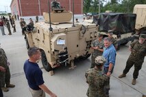 James Geurts, assistant secretary of the Navy for Research, Development and Acquisition, speaks to Marines July 17, while touring the Joint Light Tactical Vehicle fielding facility aboard Camp Lejeune, North Carolina. Program Executive Officer Land Systems is currently fielding the Corps’ first infantry battalion—3rd Battalion, 8th Marines, 2nd Marine Division—with the vehicle. (U.S. Marine Corps photo by Ashley Calingo)