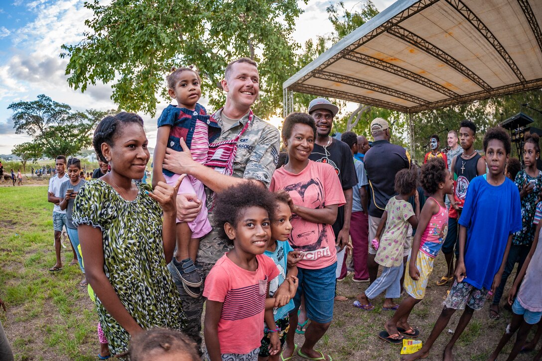SSgt Bryan Andrews spends time visititing with the audience  following a performance for members of  the Papua New Guinea Defense Force and their families.