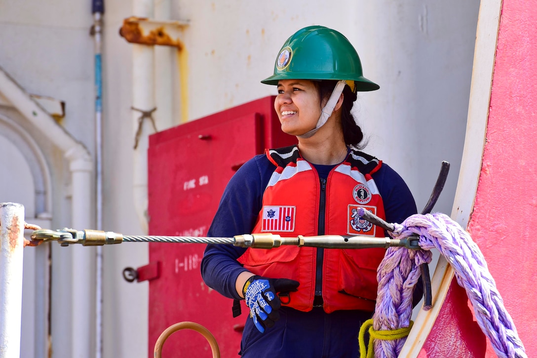 A Coast Guardsman stands on a ship.