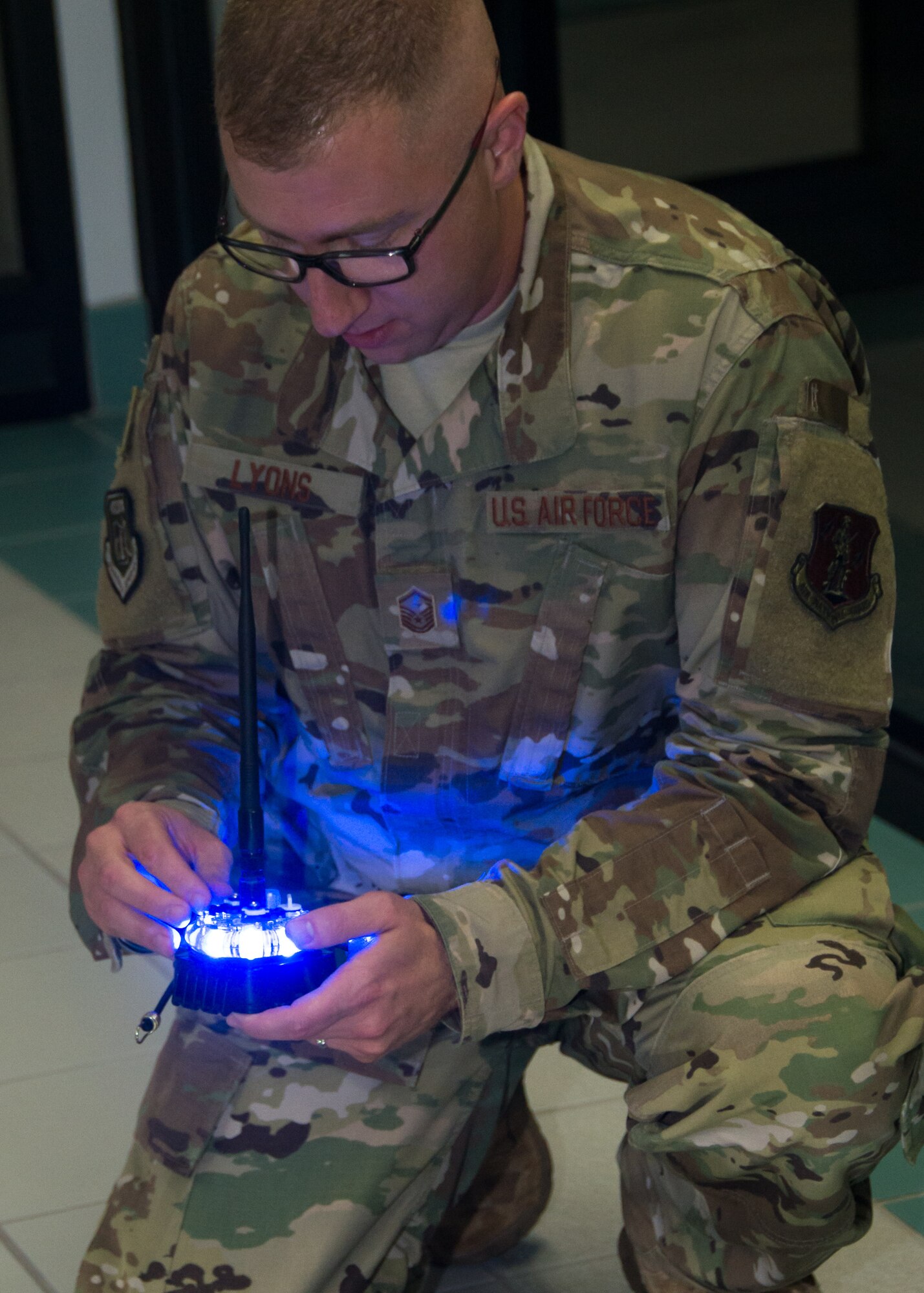 An Airman configures a Phantom Light for use in identifying a safe runway area.