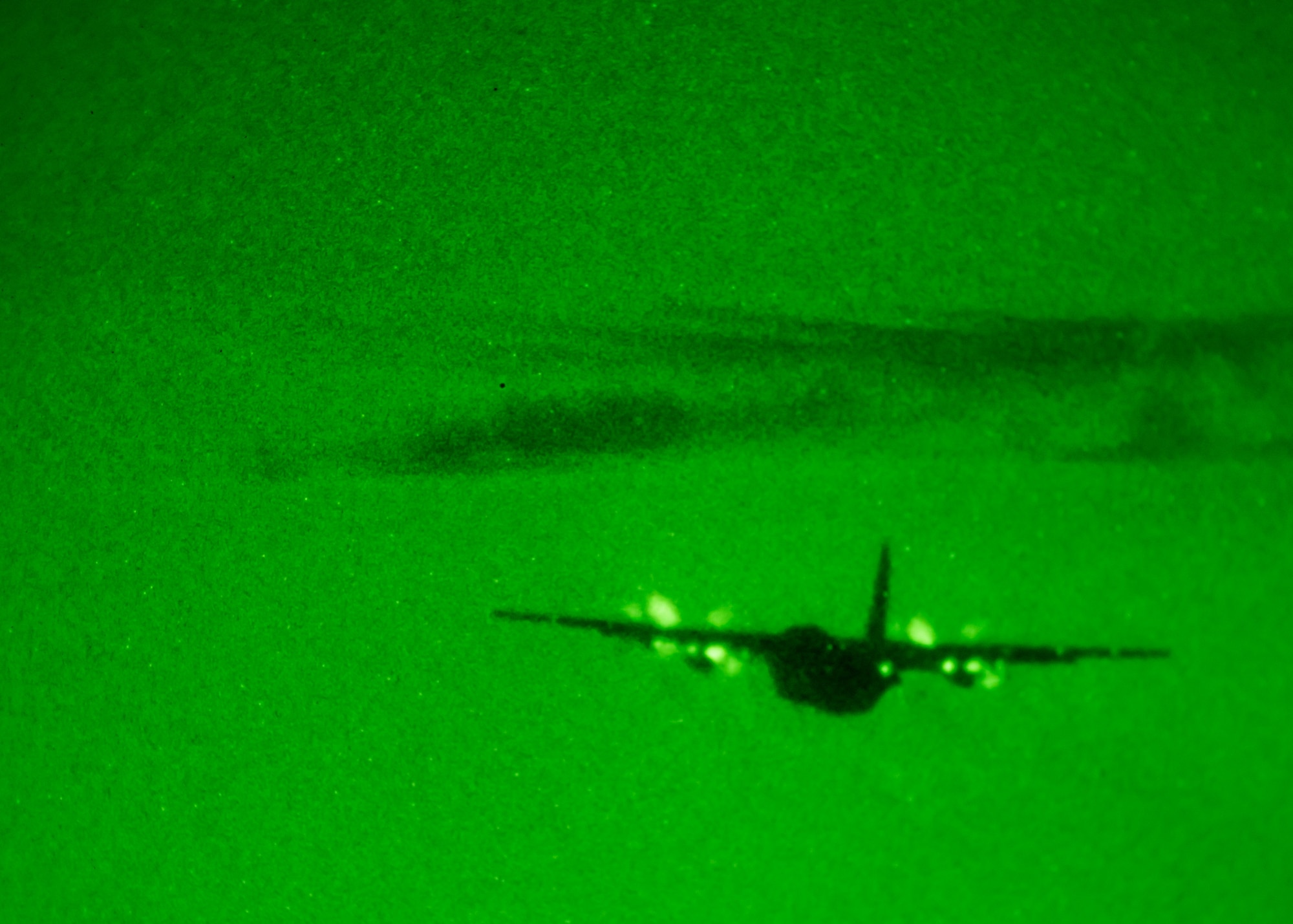 A C-130 takes off into the night.