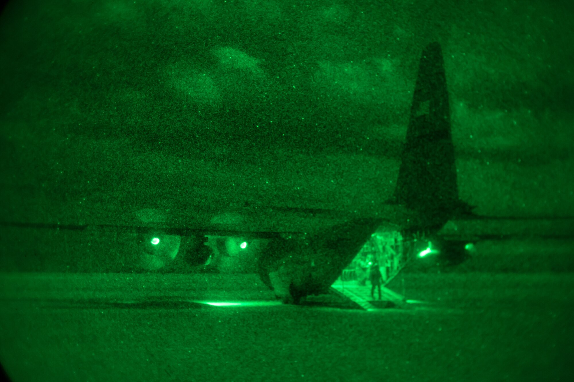 An Airman stands on the open ramp of a C-130.