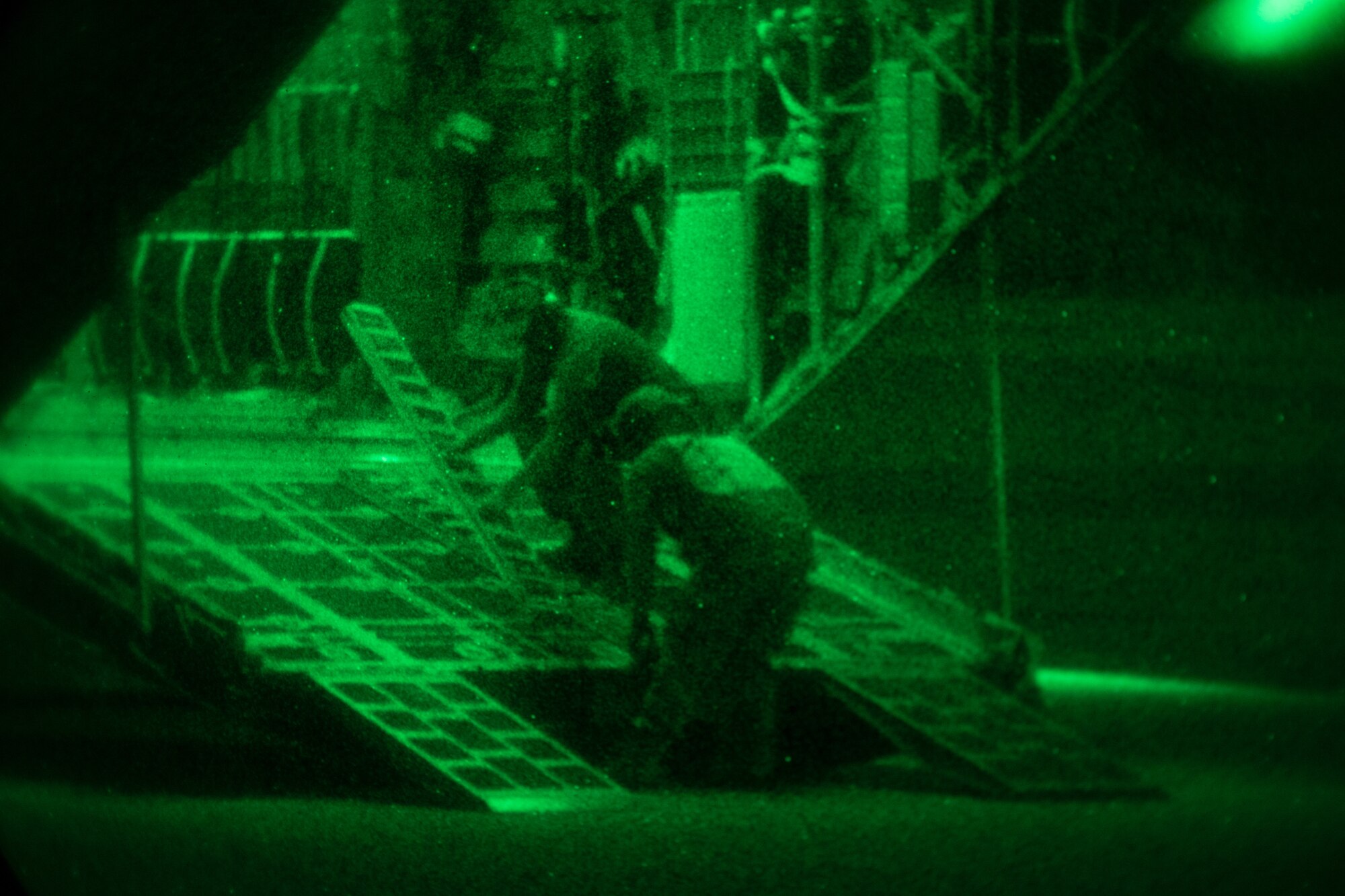 Airmen prepare the ramp of a C-130 for cargo loading.