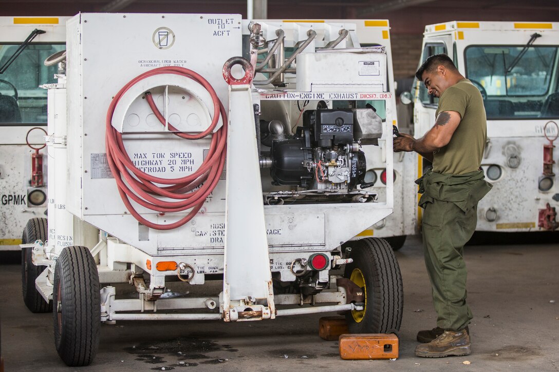 U.S. Marine Corps Lance Cpl. Alejandro Saavedra, a support equipment electrician assigned to Marine Aviation Logistics Squadron (MALS) 13, installs a fuel tank on a demineralization cart at Marine Corps Air Station (MCAS) Yuma, Ariz., July 17, 2019. (U.S. Marine Corps photo by Cpl. Sabrina Candiaflores)