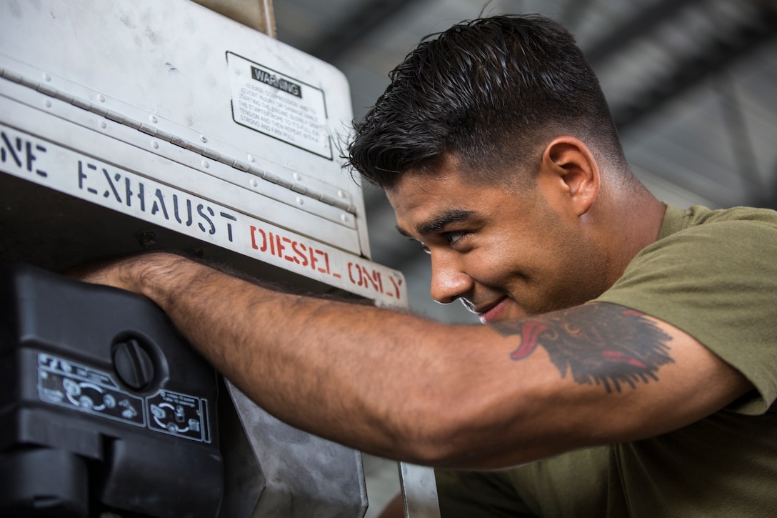 U.S. Marine Corps Lance Cpl. Alejandro Saavedra, a support equipment electrician assigned to Marine Aviation Logistics Squadron (MALS) 13, installs a fuel tank on a demineralization cart at Marine Corps Air Station (MCAS) Yuma, Ariz., July 17, 2019. (U.S. Marine Corps photo by Cpl. Sabrina Candiaflores)
