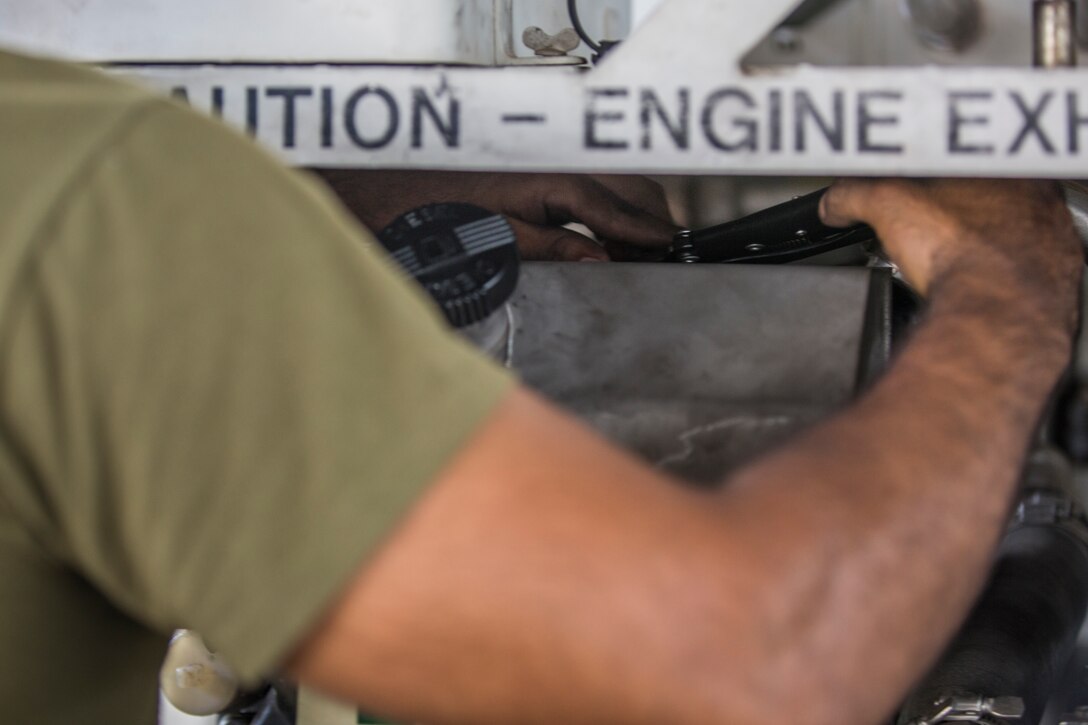 U.S. Marine Corps Lance Cpl. Alejandro Saavedra, a support equipment electrician assigned to Marine Aviation Logistics Squadron (MALS) 13, installs a fuel tank on a demineralization cart at Marine Corps Air Station (MCAS) Yuma, Ariz., July 17, 2019. (U.S. Marine Corps photo by Cpl. Sabrina Candiaflores)