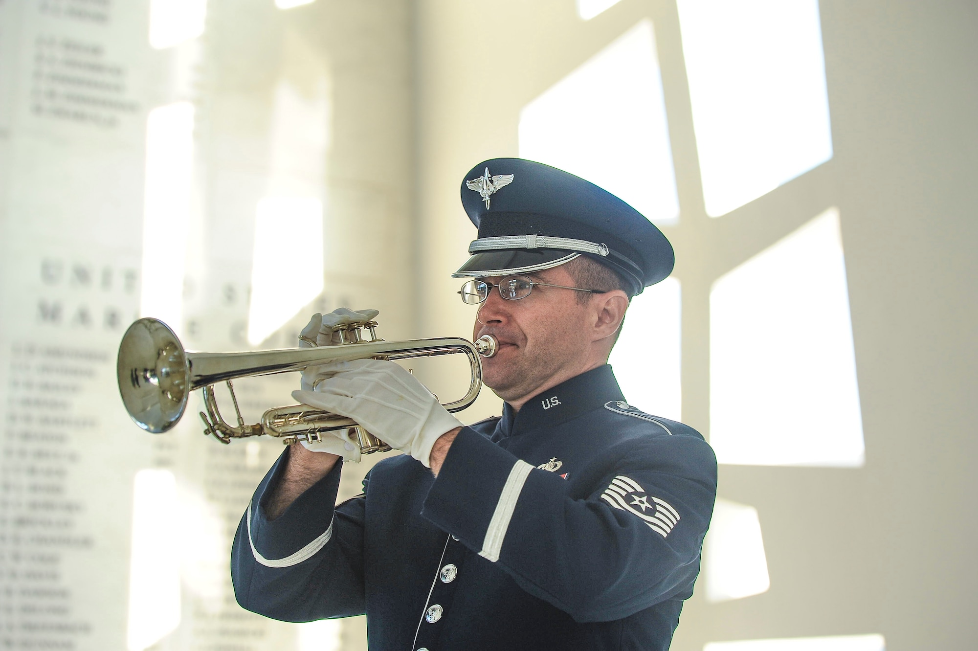 TSgt David Diamond performs taps for a ceremony on the USS Airzona Memorial in commemoration of the 75th Anniversary of the bombing at Pearl Harbor.