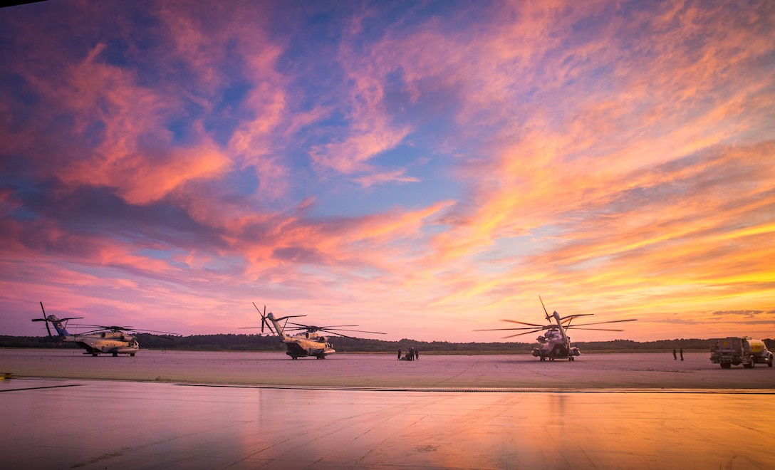 Three CH-53E Super Stallion’s with Marine Heavy Helicopter Squadron 461, are stationary on the flight line in Brunswick, Maine, July 17, 2019. The purpose of HMH-461’s deployment for training is to increase the squadron’s proficiency in mountainous terrain operations, to conduct mission essential tasks in a challenging environment, and improve combat readiness.