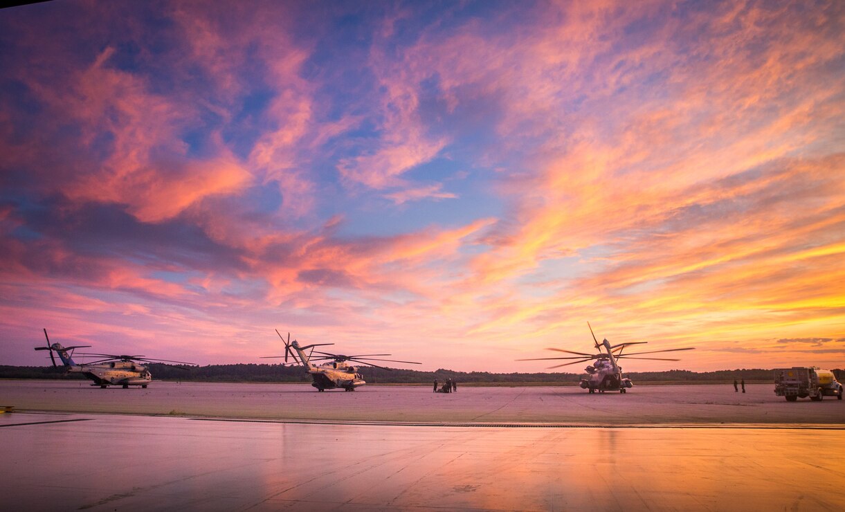 Three CH-53E Super Stallion’s with Marine Heavy Helicopter Squadron 461, are stationary on the flight line in Brunswick, Maine, July 17, 2019. The purpose of HMH-461’s deployment for training is to increase the squadron’s proficiency in mountainous terrain operations, to conduct mission essential tasks in a challenging environment, and improve combat readiness.