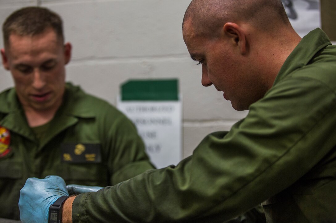 U.S. Marine Corps Lance Cpl. Billie Scott and Lance Cpl. Justin Stargell, aircraft maintenance specialists assigned to Marine Aviation Squadron (MALS) 13, break down multiple F-35B Lightning ll tires to be cleaned for their tire inspection at Marine Corps Air Station (MCAS) Yuma, Ariz., July 17, 2019. The MALS-13 Tire Shop inspects every tire they receive to ensure they are still good to use. (U.S. Marine Corps photo by Cpl. Sabrina Candiaflores)