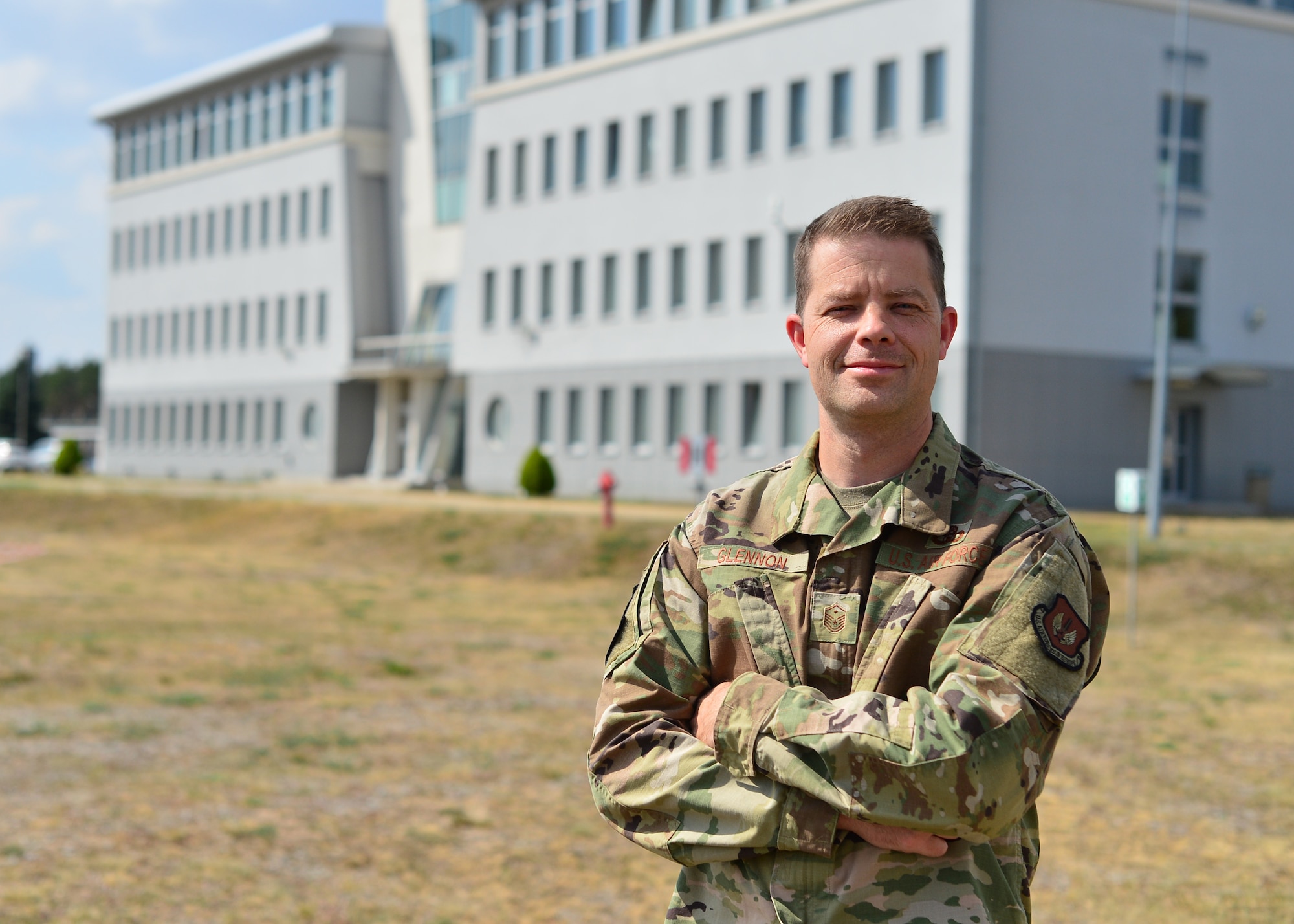 U.S. Air Force Master Sgt. Patrick Glennon, 37th Airlift Squadron first sergeant, stands outside air traffic control tower at Powidz Air Base, Poland, July 20, 2019. During Aviation Rotation 19-3, Glennon was integral to the morale and welfare of the Airmen supporting the missions by assisting with transportation, communication, and event planning. (U.S. Air Force photo by Staff Sgt. Jimmie D. Pike)