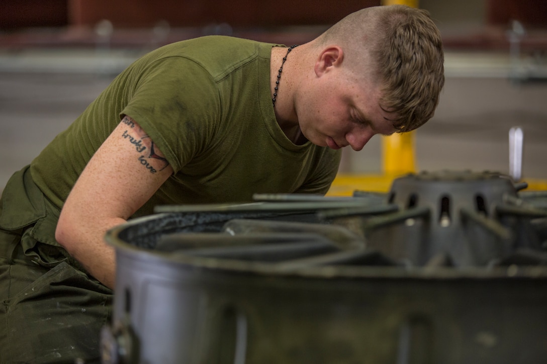 U.S. Marines assigned to Marine Aviation Logistics Squadron (MALS) 13, break down the engine of an AV-8B Harrier at Marine Corps Air Station (MCAS) Yuma, Ariz., July 17, 2019. These Marines are fixed-wing aircraft power plants mechanics. (U.S. Marine Corps photo by Cpl. Sabrina Candiaflores)