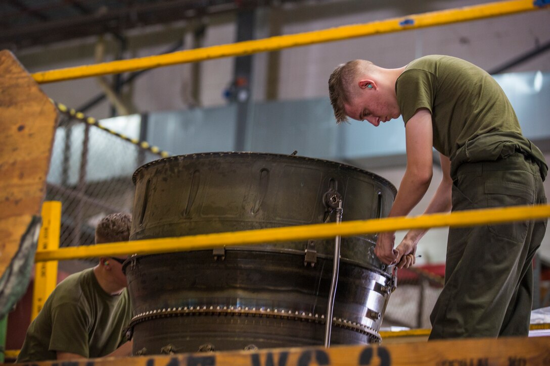 U.S. Marines assigned to Marine Aviation Logistics Squadron (MALS) 13, break down the engine of an AV-8B Harrier at Marine Corps Air Station (MCAS) Yuma, Ariz., July 17, 2019. These Marines are fixed-wing aircraft power plants mechanics. (U.S. Marine Corps photo by Cpl. Sabrina Candiaflores)