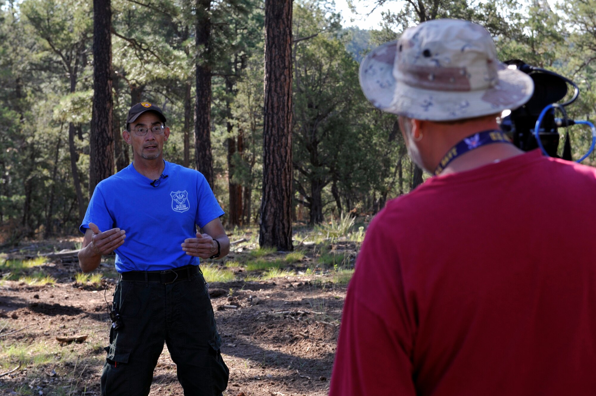 Robert Morales, Kirtland’s Wildland Support Module lead, answers media questions during a media day in the eastern-most remote forest area of Kirtland Air Force Base, N.M., July 18, 2019. The team of six wildland firefighters have thinned out 70 acres of forest expanding on the initial fuel breaks that were created since the project broke ground in spring of 2019.  (U.S. Air Force photo by Staff Sgt. Dylan Nuckolls)