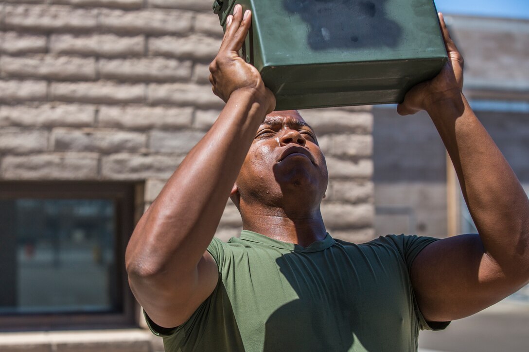 U.S. Marine Corps Lance Cpl. Ghaad Jones, an aircraft maintenance administration specialist assigned to Marine Aviation Logistics Squadron (MALS) 13, repeatedly lifts an ammunition can on his break to prepare for the Combat Fitness Test (CFT). Marines must conduct a CFT every year to ensure they are physically ready for combat situations. (U.S. Marine Corps photo by Cpl. Sabrina Candiaflores)