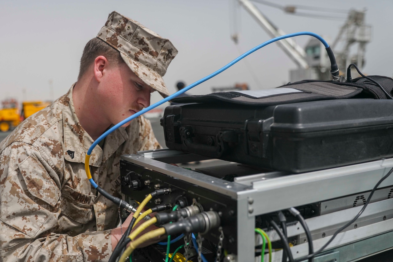 Man works on satellite components