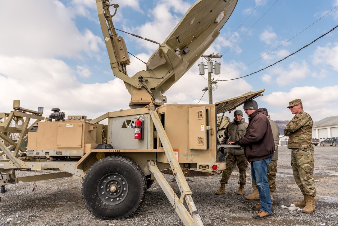 Men work on satellite