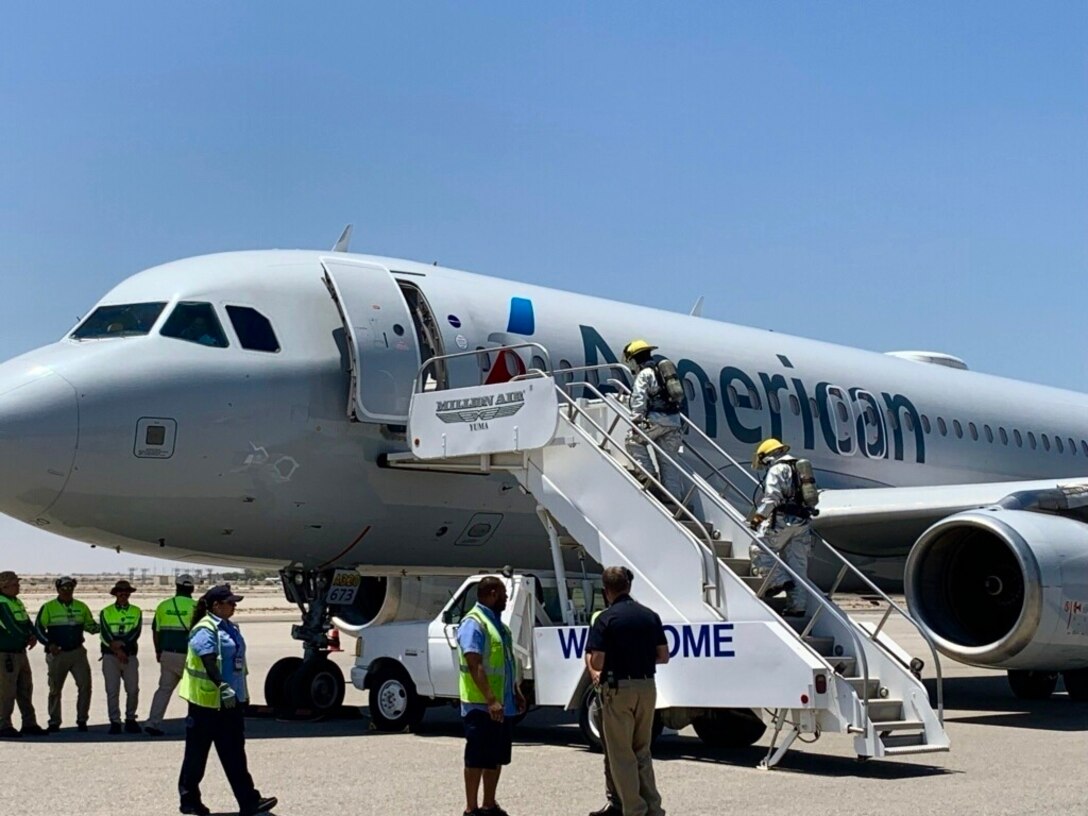 U.S. Marines assigned to Aircraft Rescue and Fire Fighting (ARFF) board the American Airlines aircraft that made an emergency landing at Marine Corps Air Station (MCAS) Yuma, Ariz., July 15, 2019. The aircraft’s pilot made contact with MCAS Yuma’s Air Traffic Control tower requesting to make an emergency landing due to smoke in the cabin of the aircraft. (U.S. Marine Corps photo by Sgt. Isaac D. Martinez)