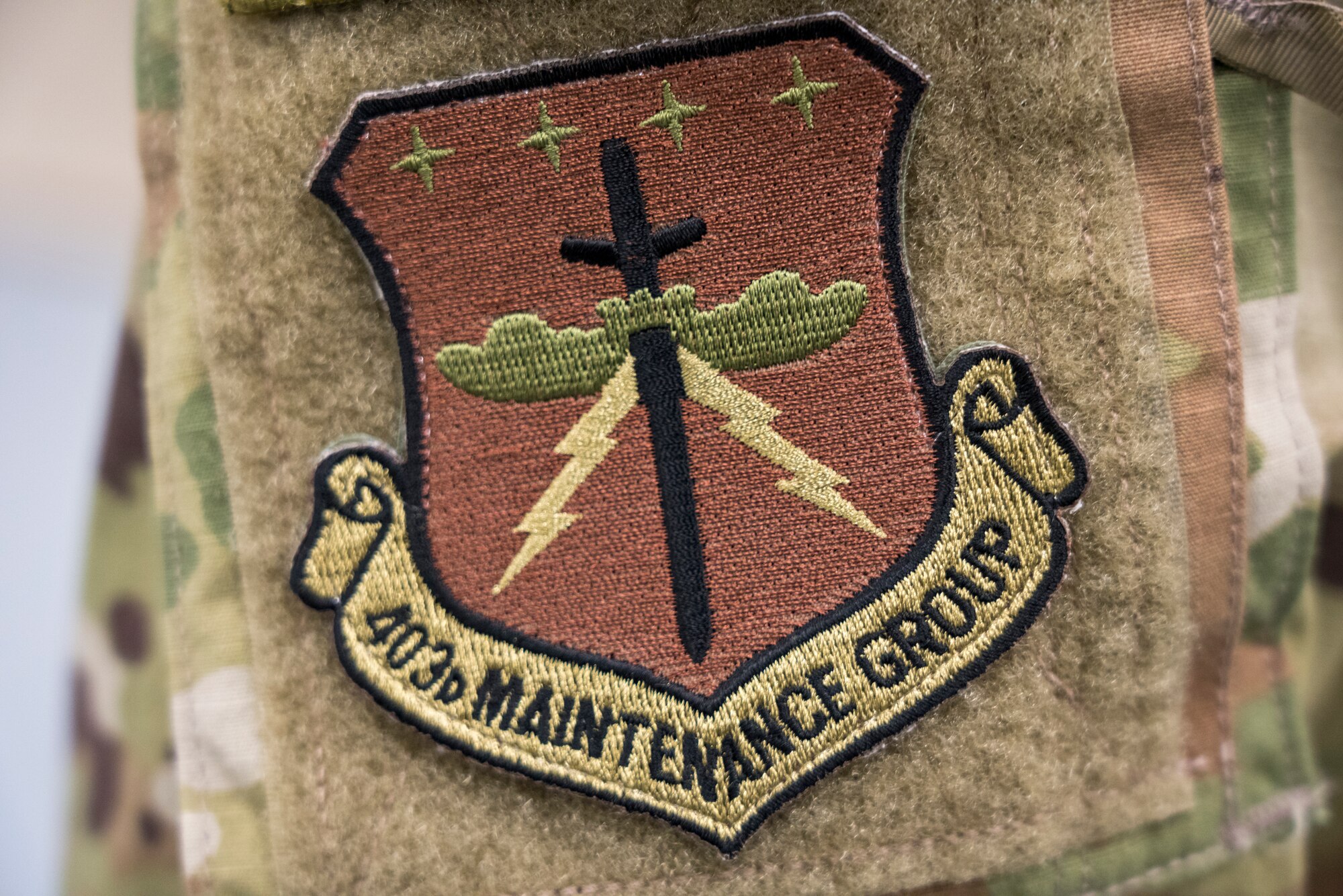 The 403rd Maintenance Group patch. The squadrons that fall under the MXG are: 403rd Maintenance Squadron, and the 403rd and 803rd Aircraft Maintenance Squadrons. (U.S. Air Force photo by Tech. Sgt. Christopher Carranza)