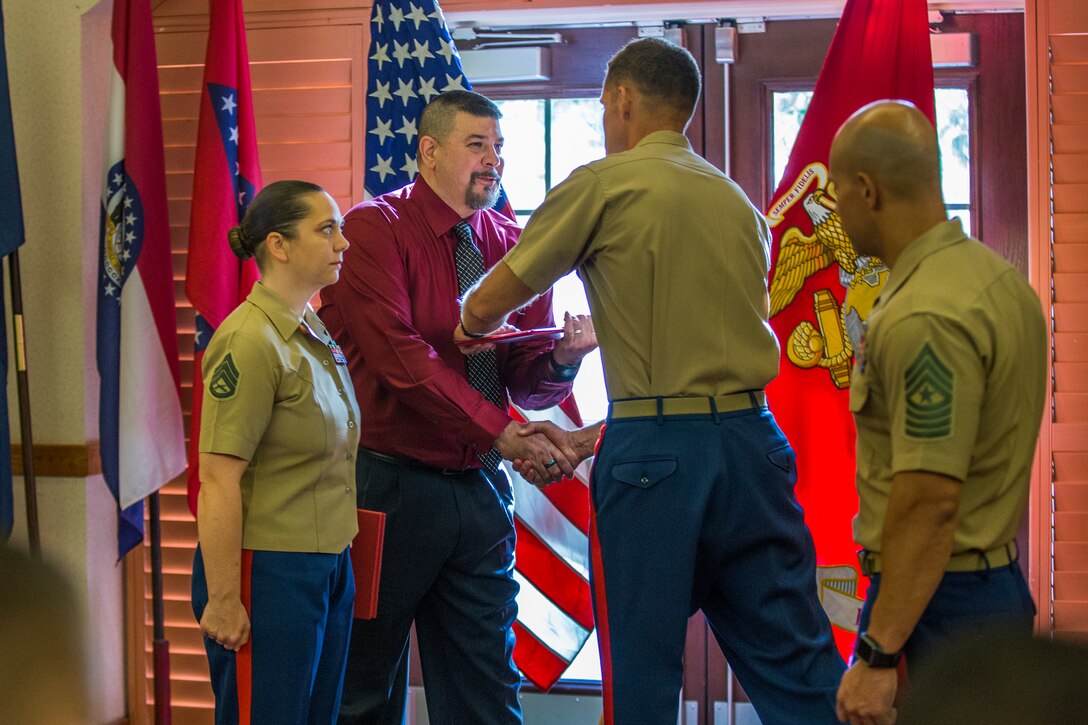 U.S. Marine Corps Staff Sgt. Nicole Showman retires after 20 years of service at the Sonoran Pueblo on Marine Corps Air Station Yuma, Ariz., July 12, 2019. Showman also received a Navy-Marine Corps Achievment Medal for her superior performance as the Headquarters and Headquarters Squadron Career Planner from June 2018 to July 2019. (U.S. Marine Corps photo by Cpl. Sabrina Candiaflores)
