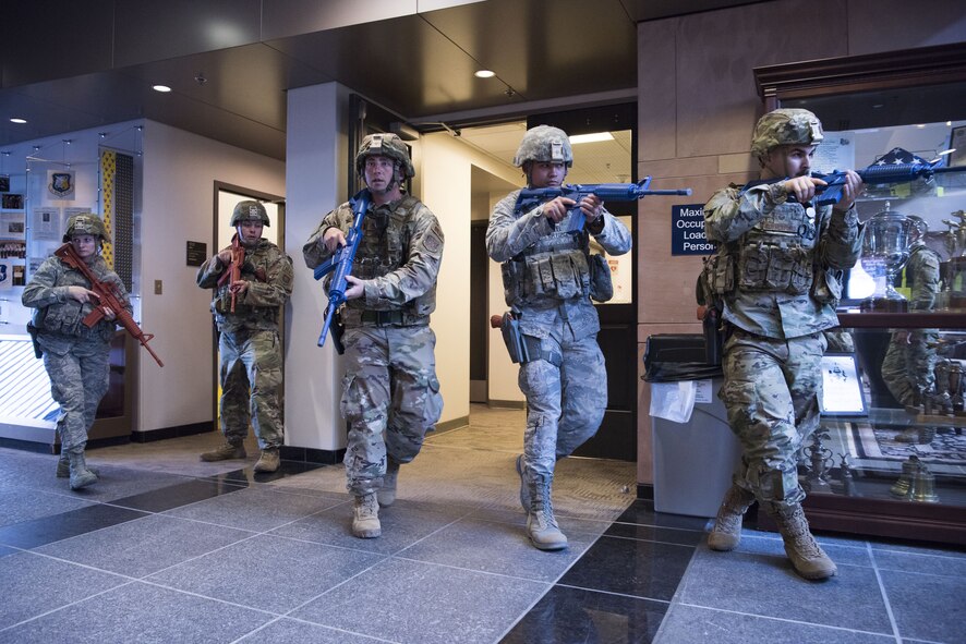 SCHRIEVER AIR FORCE BASE, Colo.--50th Security Force Squadron response force team moves to clear a building in a simulated active shooter scenario during a field training exercise at Schriever Air Force Base, Colorado, July 20, 2019. The FTX consisted of a simulated gate crash, a series of active shooters scenarios throughout the base and a squadron recall to test their mobilization.  (U.S. Air Force photo by Staff Sgt. Matthew Coleman-Foster)