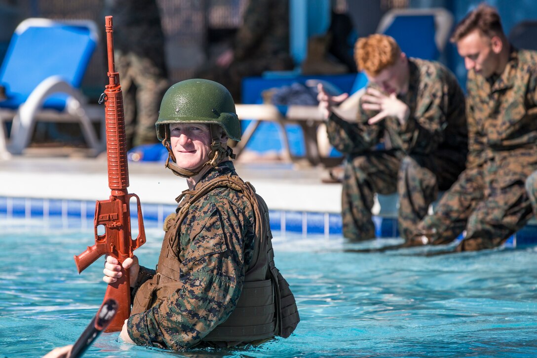U.S. Marines stationed at Marine Corps Air Station (MCAS) Yuma conduct their swim qualification at the Oasis Pool on MCAS Yuma, Ariz., July 10, 2019. The swim qualification is designed to reduce fear, raise self-confidence, and develop Marines with the ability to survive in water. (U.S. Marine Corps photo by Cpl. Sabrina Candiaflores)