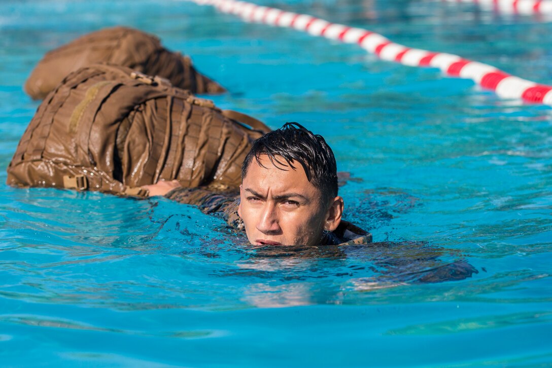 U.S. Marines stationed at Marine Corps Air Station (MCAS) Yuma conduct their swim qualification at the Oasis Pool on MCAS Yuma, Ariz., July 10, 2019. The swim qualification is designed to reduce fear, raise self-confidence, and develop Marines with the ability to survive in water. (U.S. Marine Corps photo by Cpl. Sabrina Candiaflores)