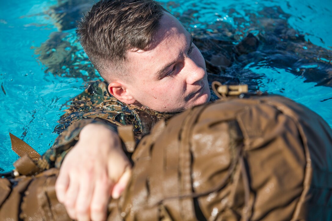 U.S. Marines stationed at Marine Corps Air Station (MCAS) Yuma conduct their swim qualification at the Oasis Pool on MCAS Yuma, Ariz., July 10, 2019. The swim qualification is designed to reduce fear, raise self-confidence, and develop Marines with the ability to survive in water. (U.S. Marine Corps photo by Cpl. Sabrina Candiaflores)