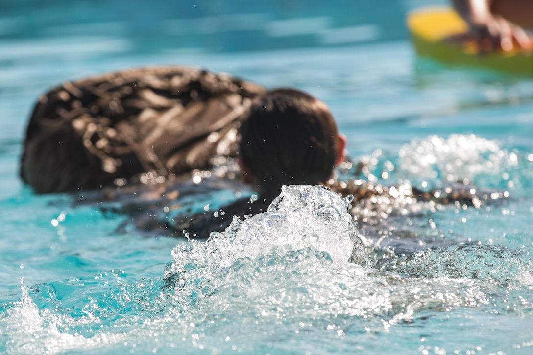 U.S. Marines stationed at Marine Corps Air Station (MCAS) Yuma conduct their swim qualification at the Oasis Pool on MCAS Yuma, Ariz., July 10, 2019. The swim qualification is designed to reduce fear, raise self-confidence, and develop Marines with the ability to survive in water. (U.S. Marine Corps photo by Cpl. Sabrina Candiaflores)