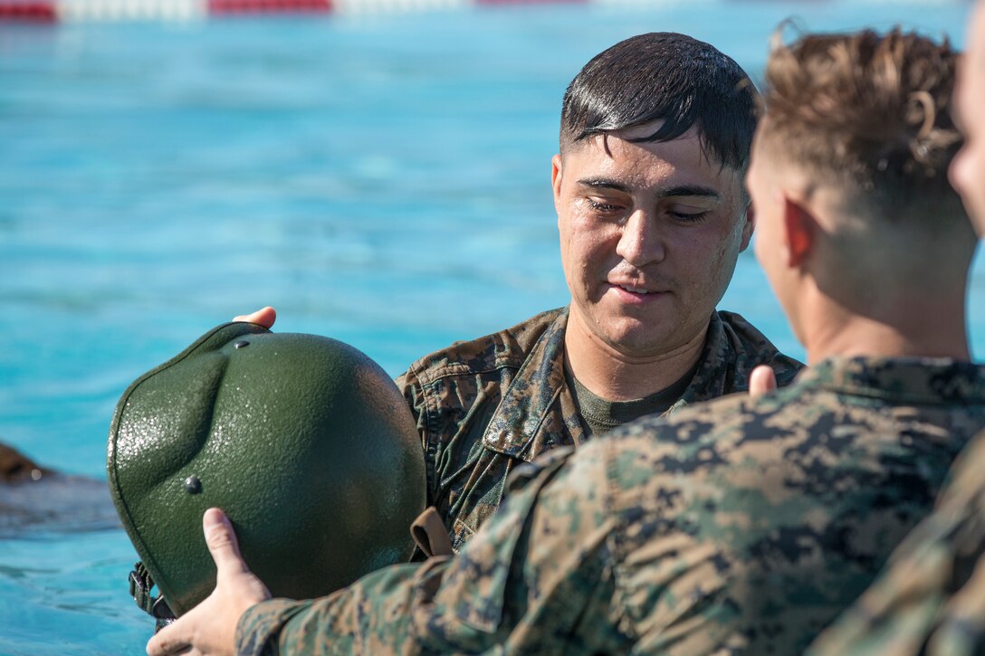 U.S. Marines stationed at Marine Corps Air Station (MCAS) Yuma conduct their swim qualification at the Oasis Pool on MCAS Yuma, Ariz., July 10, 2019. The swim qualification is designed to reduce fear, raise self-confidence, and develop Marines with the ability to survive in water. (U.S. Marine Corps photo by Cpl. Sabrina Candiaflores)