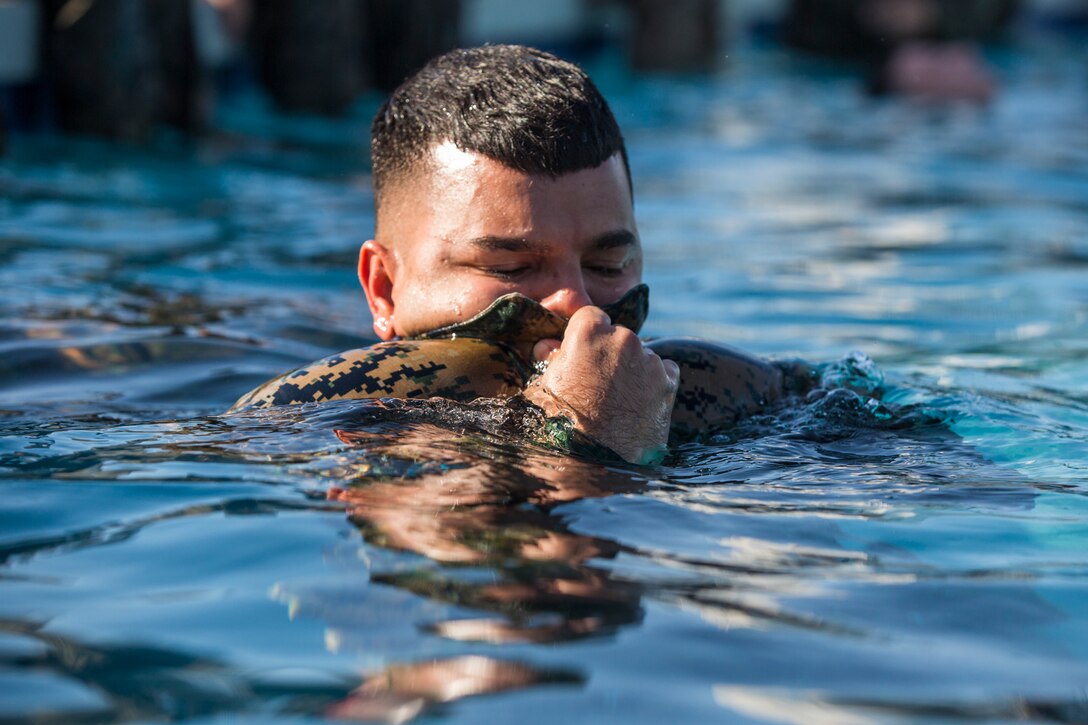 U.S. Marines stationed at Marine Corps Air Station (MCAS) Yuma conduct their swim qualification at the Oasis Pool on MCAS Yuma, Ariz., July 10, 2019. The swim qualification is designed to reduce fear, raise self-confidence, and develop Marines with the ability to survive in water. (U.S. Marine Corps photo by Cpl. Sabrina Candiaflores)