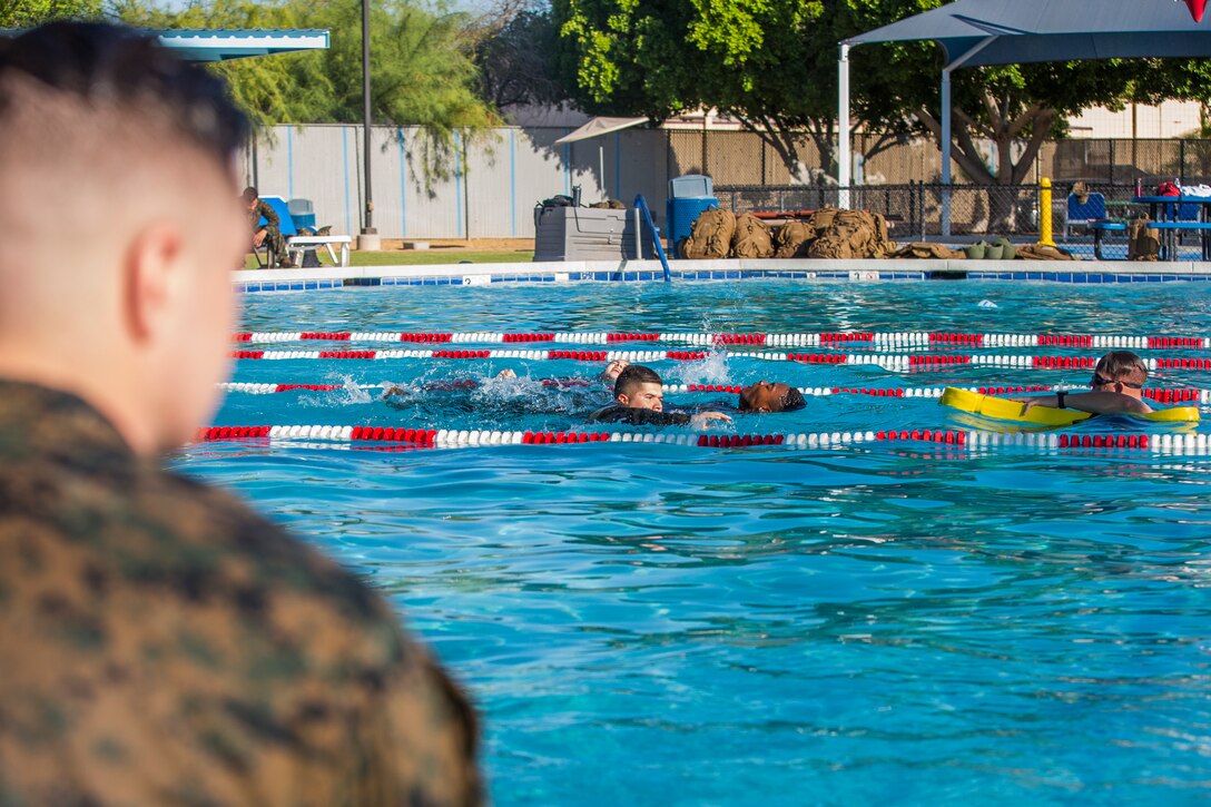 U.S. Marines stationed at Marine Corps Air Station (MCAS) Yuma conduct their swim qualification at the Oasis Pool on MCAS Yuma, Ariz., July 10, 2019. The swim qualification is designed to reduce fear, raise self-confidence, and develop Marines with the ability to survive in water. (U.S. Marine Corps photo by Cpl. Sabrina Candiaflores)