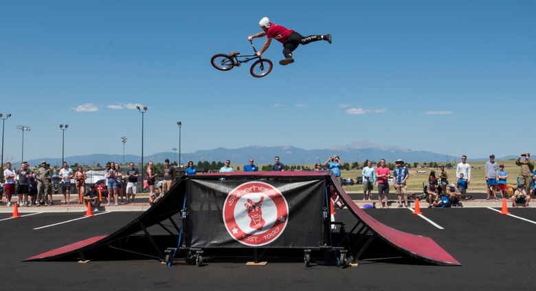 Dan Setmeyer, Superhero Stunt Team BMX stunt rider, performs a trick at the Summer Slam base picnic at Schriever Air Force Base, Colorado, July 19, 2019. The BMX show had four experienced riders who performed tricks in front of the crowd. (U.S. Air Force photo by Airman 1st Class Jonathan Whitely)