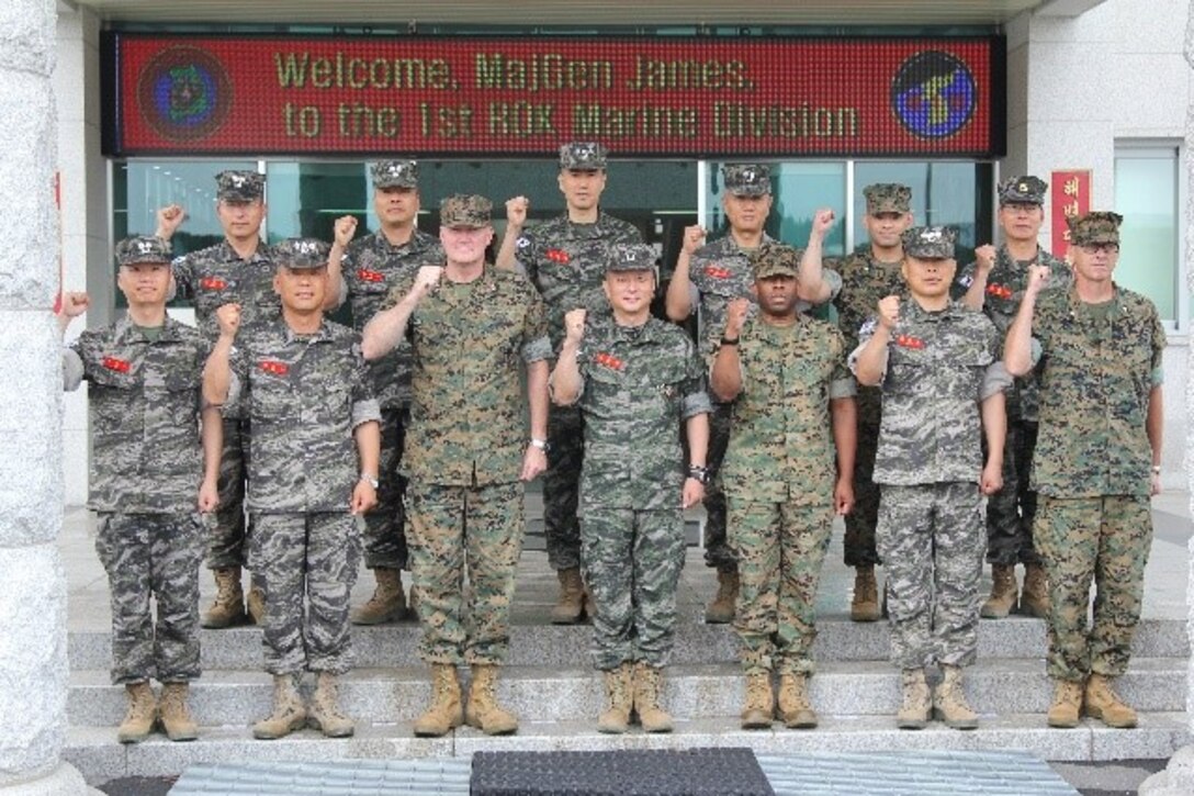 Marine leadership with U.S. Marine Forces Korea and the Republic of Korea Marine Corps join in raising a fist of solidarity for the iron-clad alliance between the two nations and services. This was part of a visit to the 1st ROK Marine Division Headquarters by Maj. Gen. Bradley S. James, Commander of Marine Forces Korea.  James’ visit was part of his first peninsula tour to build relationships between the two nations and services and strengthen the ROK-U.S. Alliance. (U.S. Marine Corps photo by SSgt. Mel Johnson)