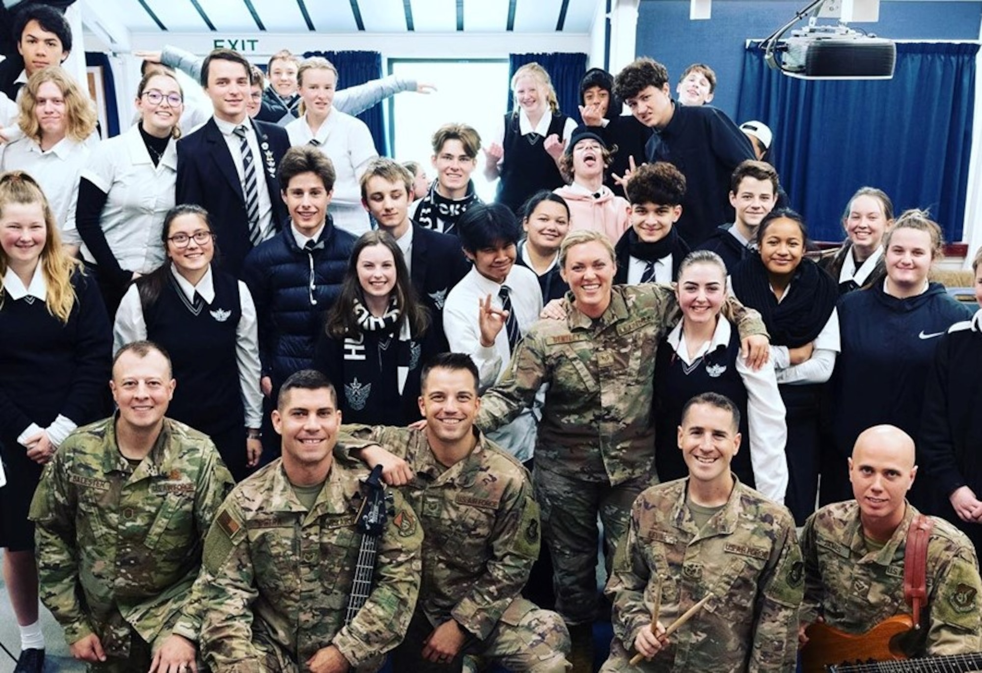 The members of Small Kine pose for a photo with the students of Hutt Valley High School in Wellington, New Zealand.