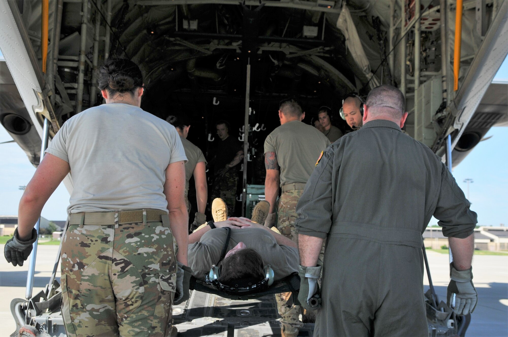 Members of Pope’s 43d Aeromedical Evacuation Squadron (AES) load a patient on the aircraft as part of a tandem Aeromedical Readiness Mission.