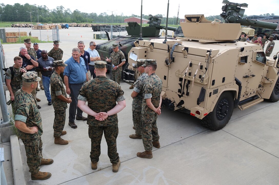 James Geurts, assistant secretary of the Navy for Research, Development and Acquisition, speaks to Marines July 17, while touring the Joint Light Tactical Vehicle fielding facility aboard Camp Lejeune, North Carolina. Program Executive Officer Land Systems is currently fielding the Corps’ first infantry battalion—3rd Battalion, 8th Marines, 2nd Marine Division—with the vehicle. (U.S. Marine Corps photo by Ashley Calingo)