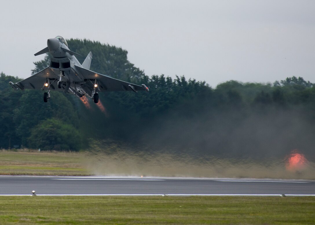 A Royal Air Force Eurofighter Typhoon FGR4 flies past the audience during the 2019 Royal International Air Tattoo at RAF Fairford, England, July 20, 2019. This year, RIAT commemorated the 70th anniversary of NATO and highlighted the United States' enduring commitment to its European allies. (U.S. Air Force photo by Airman 1st Class Jennifer Zima)