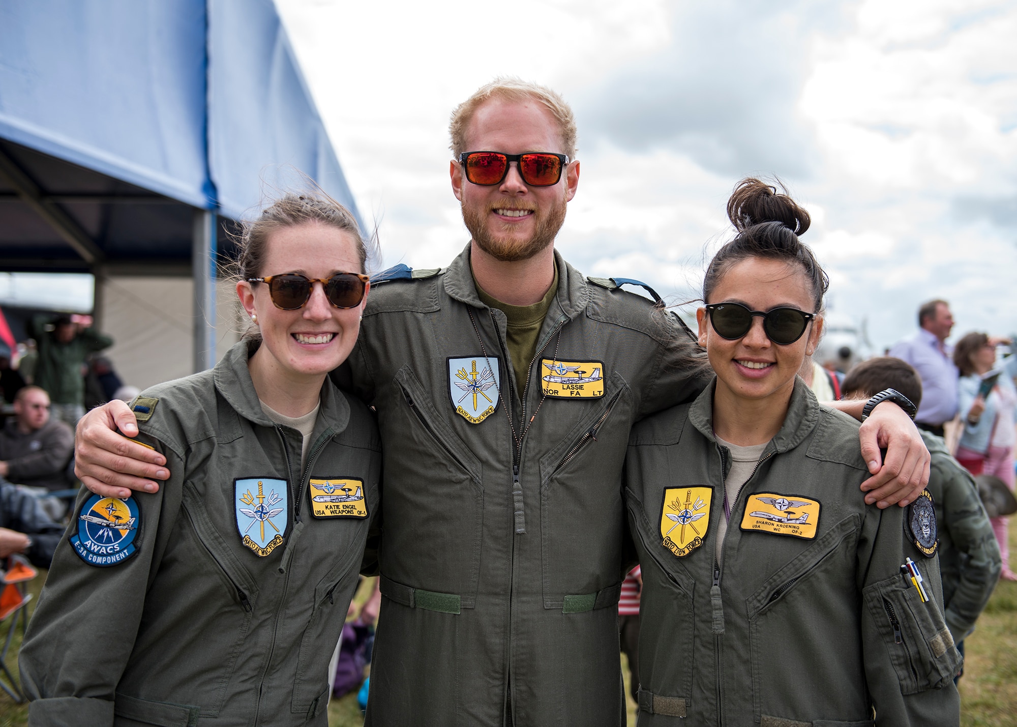 U.S. Air Force 1st Lt. Katie Engel, Squadron 2 NATO Airborne Warning and Control System weapons controller (left), Norwegian Air Force Lt. Lassie Ostbye, Squadron 2 NATO AWACS fighter allocator (center), and U.S. Air Force Capt. Sharon Kroening, Squadron 2 NATO AWACS weapons controller (right), pose for a group photo during the 2019 Royal International Air Tattoo at RAF Fairford, England, July 20, 2019. This year's RIAT commemorated the 70th anniversary of NATO and highlighted the United States' enduring commitment to its European allies. (U.S. Air Force photo by Airman 1st Class Jennifer Zima)