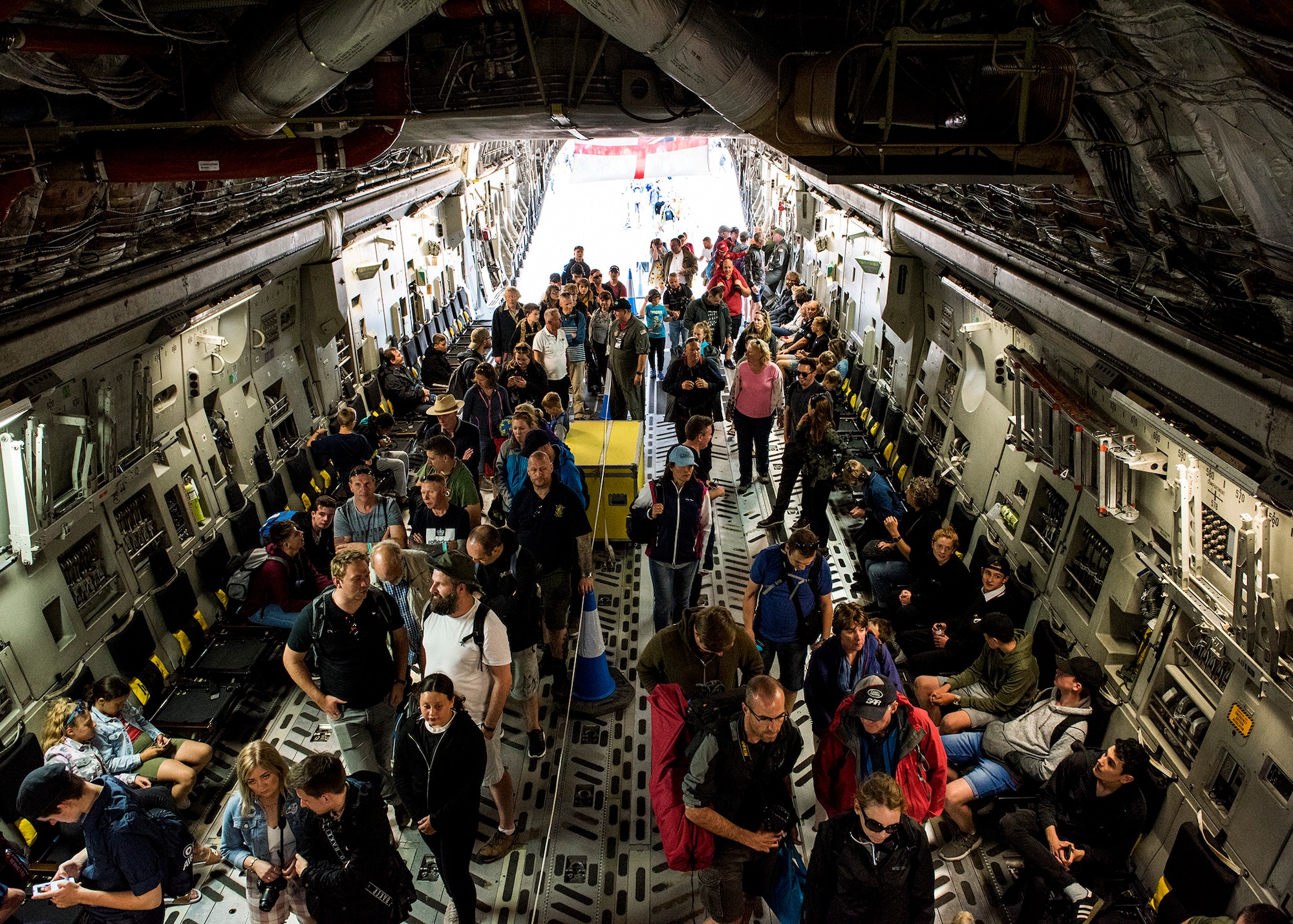 U.S. Air Force service members from the 315th Airlift Wing host tours for the public inside a C-17 Globemaster III on static display from Charleston Air Force Base, South Carolina, during the 2019 Royal International Air Tattoo at RAF Fairford, England, July 20, 2019. This year's RIAT commemorated the 70th anniversary of NATO and highlighted the United States' enduring commitment to its European allies. (U.S. Air Force photo by Airman 1st Class Jennifer Zima)