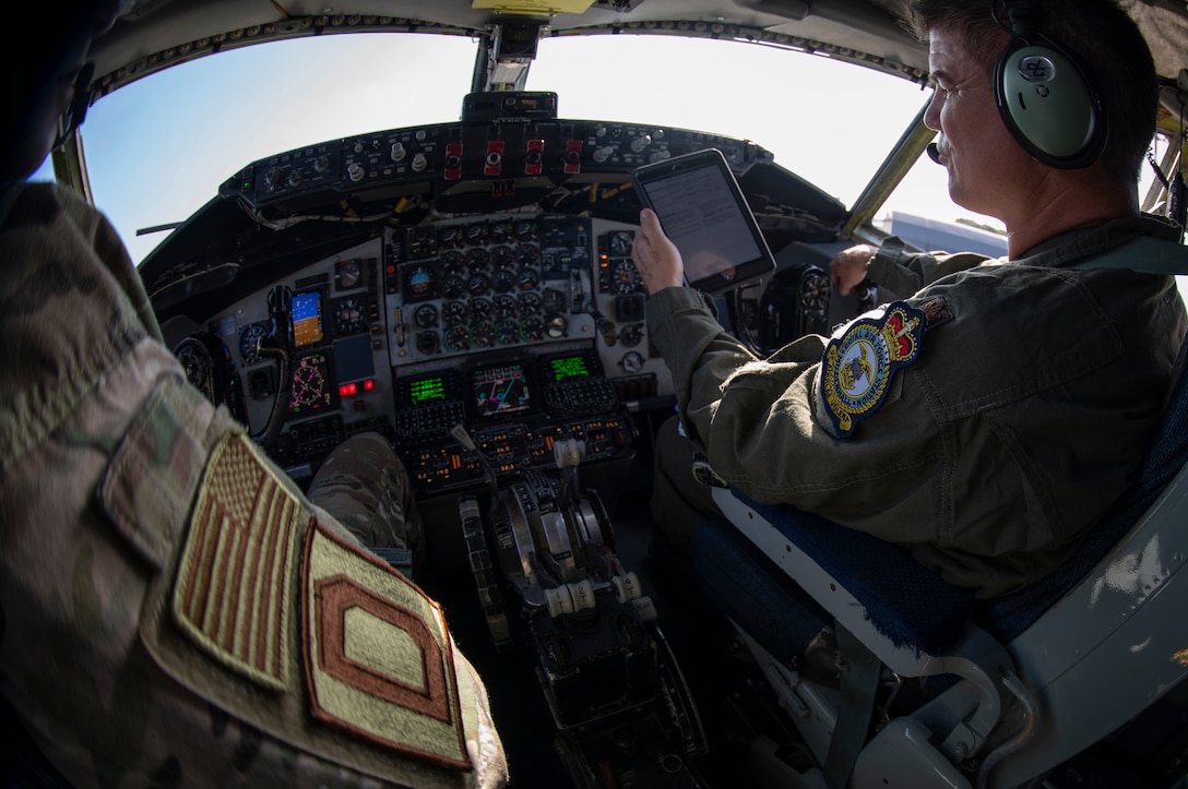 U.S. Air Force Maj. Jared Alden, 100th Air Refueling Wing command and control operations chief, left, and Maj. Matthew Koerschner, 351st Air Refueling Squadron pilot, prepare for take-off aboard a KC-135 Stratotanker prior to a flight supporting Operation Rapid Forge at RAF Mildenhall, England, July 23, 2019. Rapid Forge aircraft are forward deploying to bases in the territory of NATO allies. Participation in multinational operations enhances the U.S. Air Force’s professional relationship with partner militaries. (U.S. Air Force photo by Tech. Sgt. Emerson Nuñez)