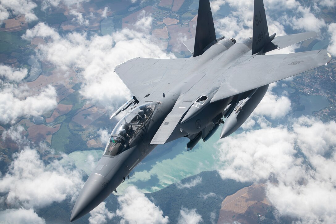 A U.S. Air Force F-15E Strike Eagle, assigned to the 4th Fighter Wing, Seymour Johnson Air Force Base, North Carolina, flies away from a KC-135 Stratotanker assigned to the 351st Air Refueling Squadron, RAF Mildenhall, England, after receiving fuel during Operation Rapid Forge over Germany, July 23, 2019. Rapid Forge aircraft are forward deploying to bases in the territory of NATO allies in order to enhance readiness and improve interoperability. The goal of the operation is to enhance readiness in coordination with U.S. allies and partners in Europe. (U.S. Air Force photo by Tech. Sgt. Emerson Nuñez)