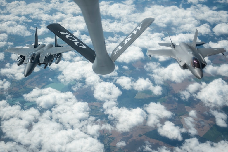 A U.S. Air Force F-15E Strike Eagle, assigned to the 4th Fighter Wing, Seymour Johnson Air Force Base, North Carolina, and a U.S. Air Force F-35A Lightning II assigned to the 388th Fighter Wing, Hill Air Force Base, Utah, fly side-by-side behind a KC-135 Stratotanker assigned to the 351st Air Refueling Squadron, RAF Mildenhall, England, during Operation Rapid Forge over Germany, July 23, 2019. Rapid Forge is a U.S. Air Forces in Europe-sponsored training event designed to enhance interoperability with NATO allies and partners, improve readiness and sharpen operational capabilities. (U.S. Air Force photo by Tech. Sgt. Emerson Nuñez)
