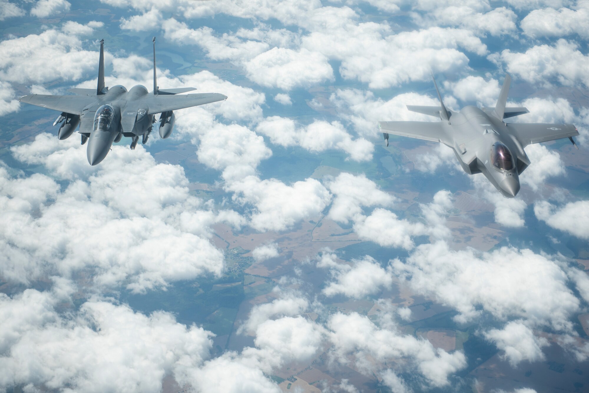 A U.S. Air Force F-15E Strike Eagle, assigned to the 4th Fighter Wing, Seymour Johnson Air Force Base, North Carolina, and a U.S. Air Force F-35A Lightning II assigned to the 388th Fighter Wing, Hill Air Force Base, Utah, fly side-by-side behind a KC-135 Stratotanker assigned to the 351st Air Refueling Squadron, RAF Mildenhall, England, during Operation Rapid Forge over Germany, July 23, 2019. Rapid Forge is a U.S. Air Forces in Europe-sponsored training event designed to enhance interoperability with NATO allies and partners, improve readiness and sharpen operational capabilities. (U.S. Air Force photo by Tech. Sgt. Emerson Nuñez)